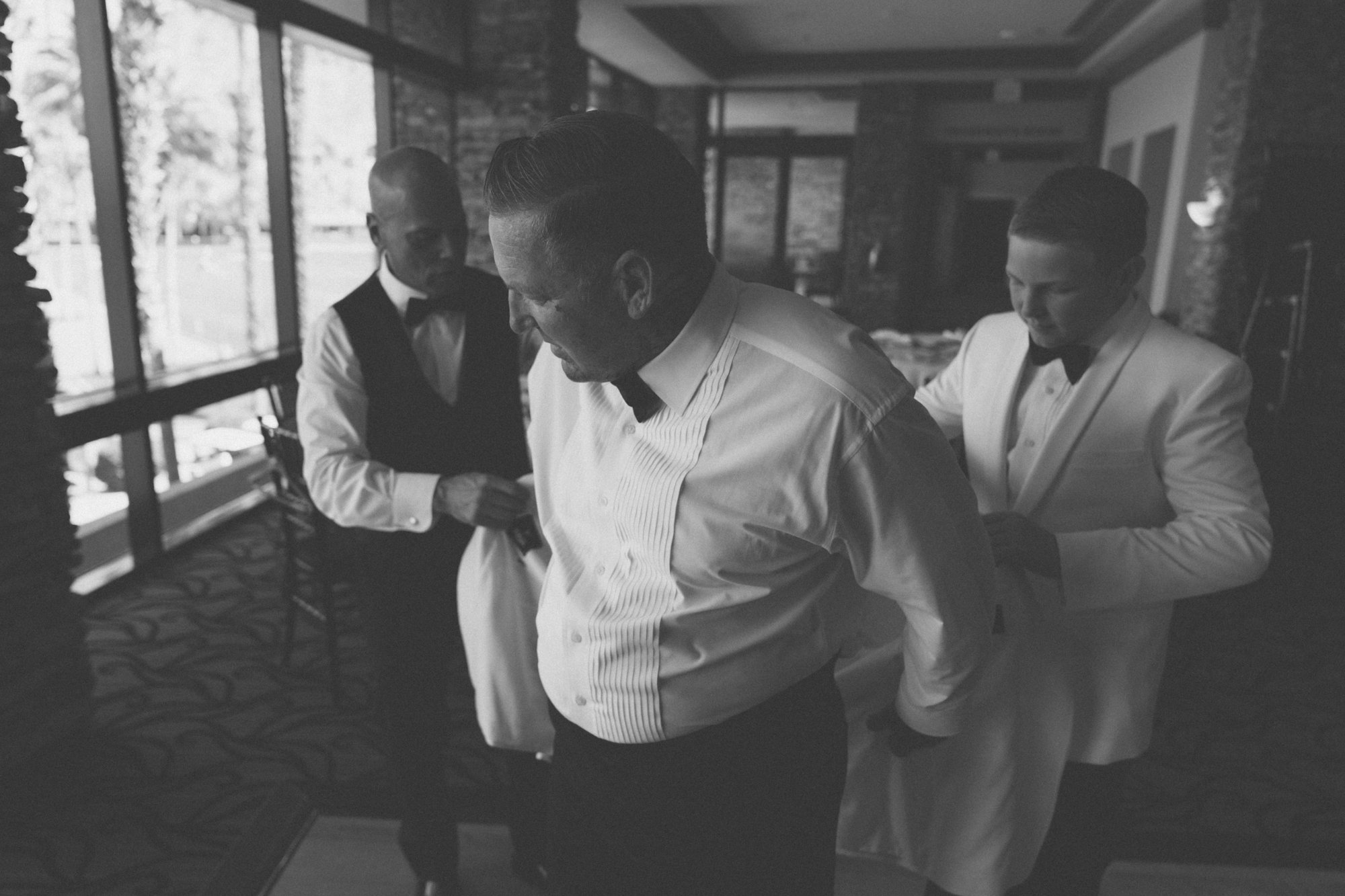 Groom getting ready with groomsmen, Coachella Valley wedding photography in black and white